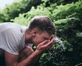 man washing his face
