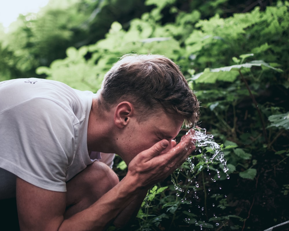 man washing his face