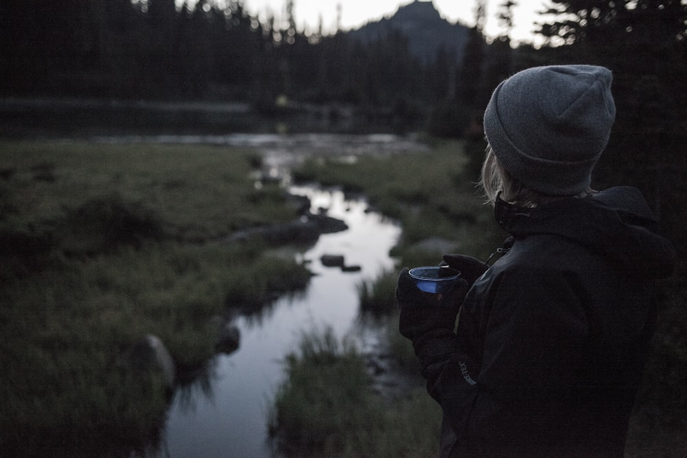 woman standing beside water