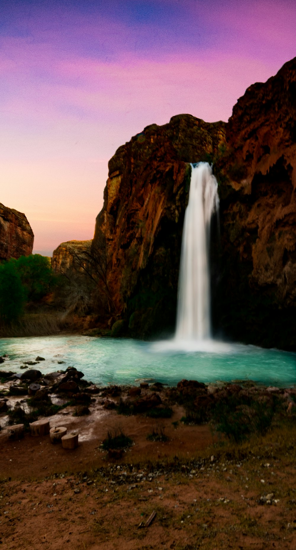 waterfall pouring on body of water