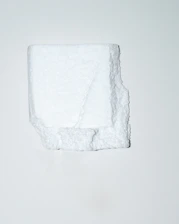 Close-up of white expanded polystyrene casetones stacked neatly in a workshop.