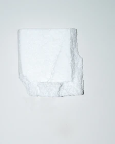 Close-up of white expanded polystyrene casetones stacked neatly in a workshop.