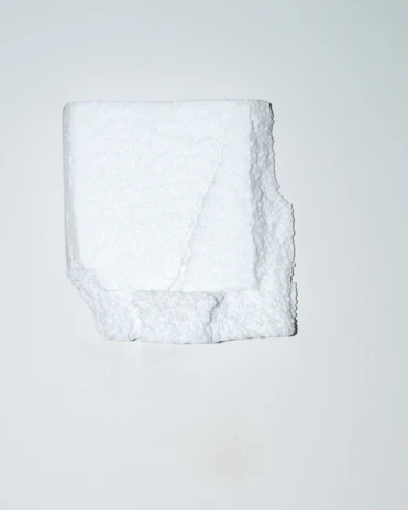 Close-up of a soft, white memory foam roll with a smooth texture.