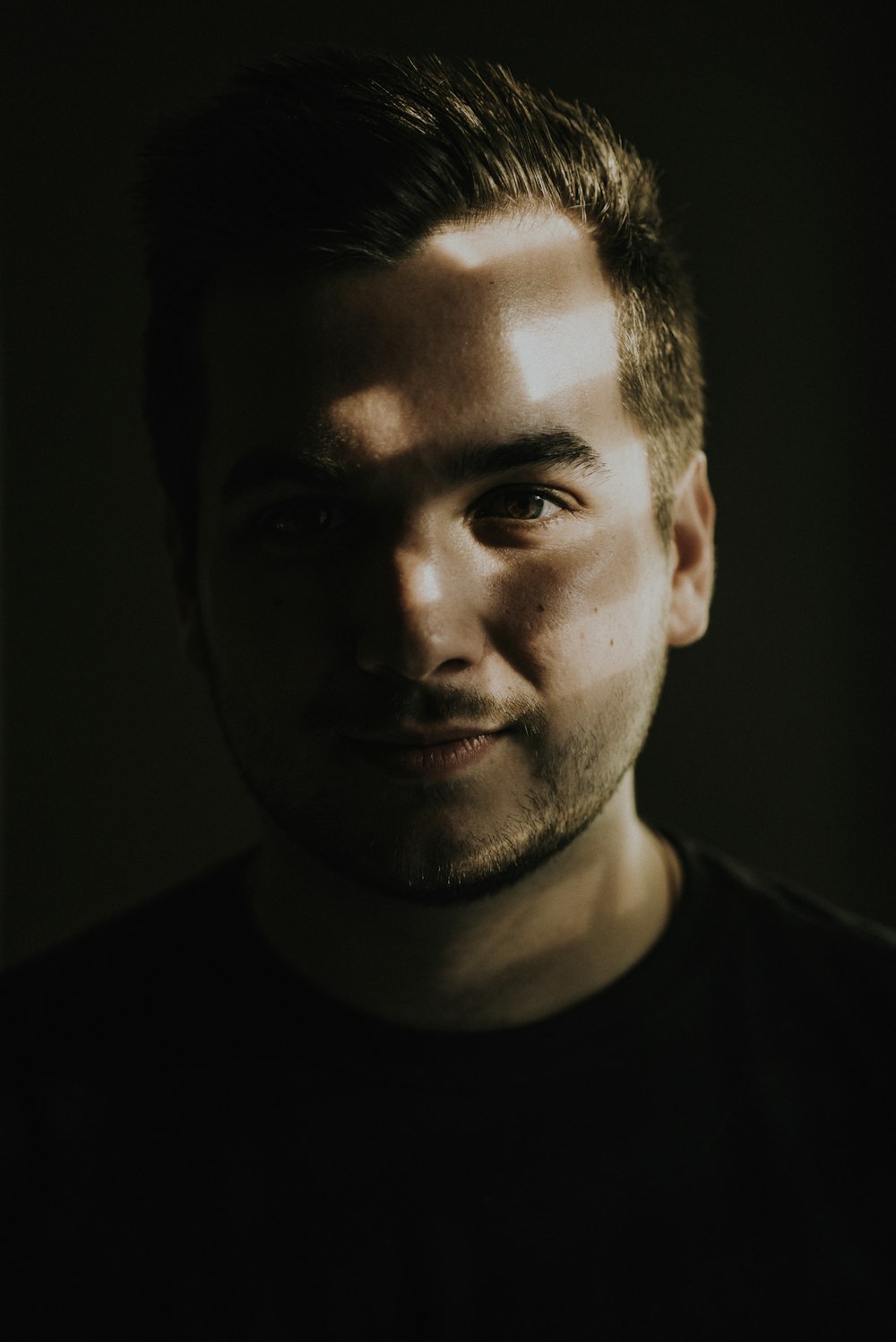 portrait photography of sunlight reflecting on man's face