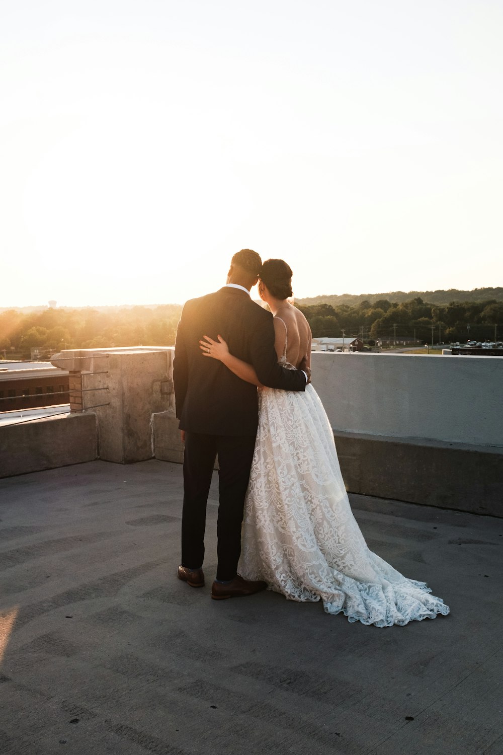 bride and groom standing on rooftop