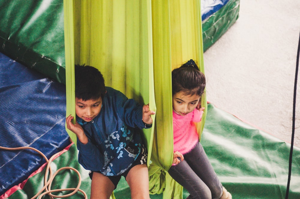 two kids playing on hammock