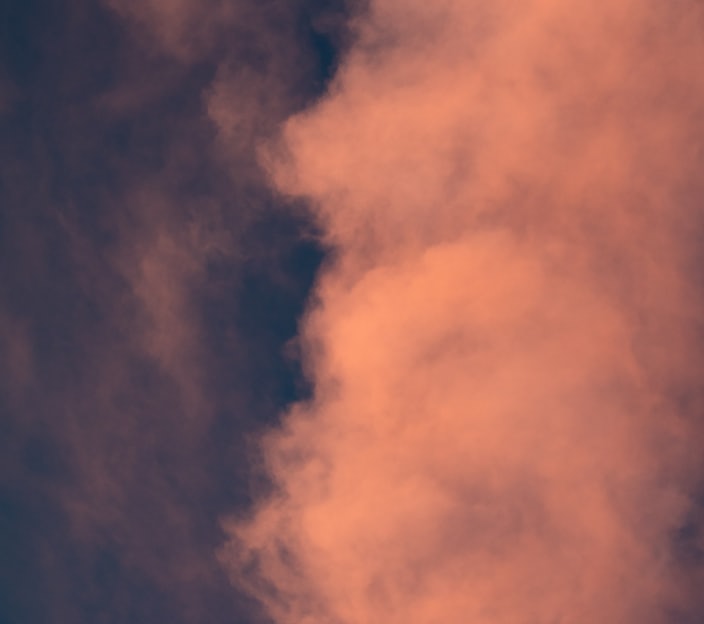 low angle photo of white clouds during twilight