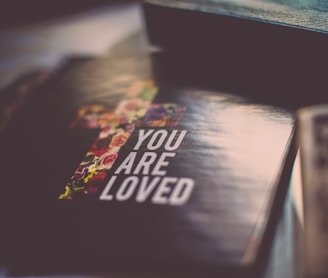 selective focus photography of You Are Loved book