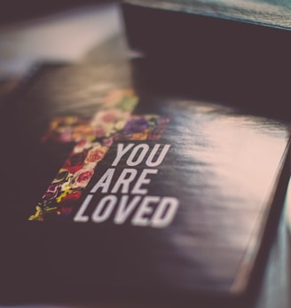 selective focus photography of You Are Loved book