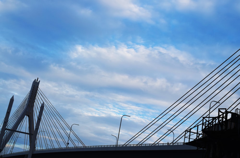 black metal bridge under white clouds during daytime