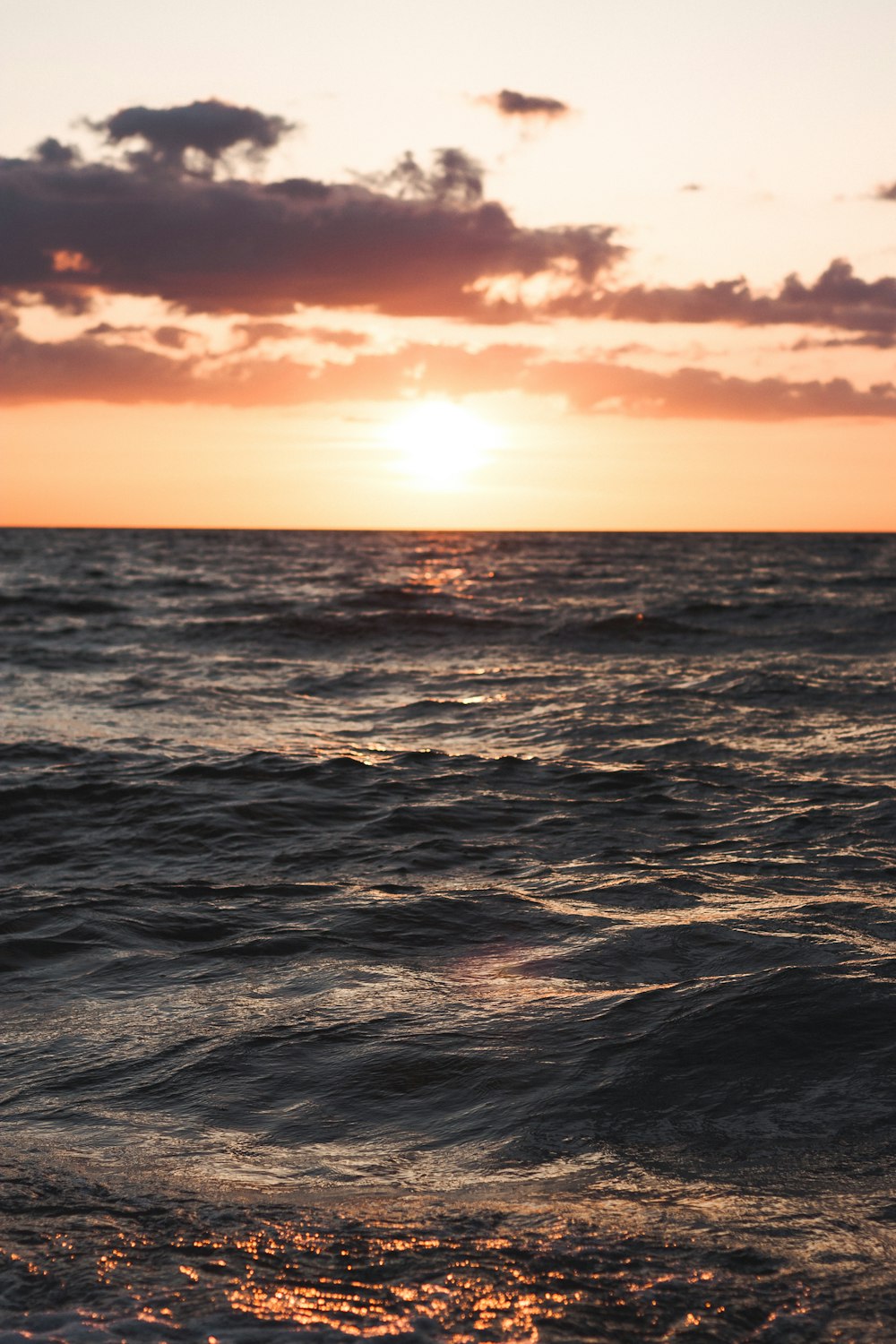 body of water over sunset