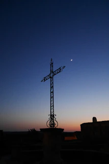A dark fantasy card featuring a monolithic cross silhouetted against a blood-red eclipse with intricate cross-hatching details.