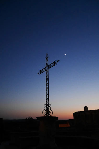A dark fantasy card featuring a monolithic cross silhouetted against a blood-red eclipse with intricate cross-hatching details.