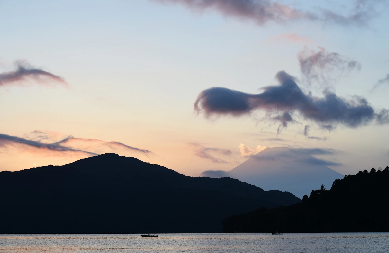 Mount Fuji rising beyond the still water of Lake Ashi