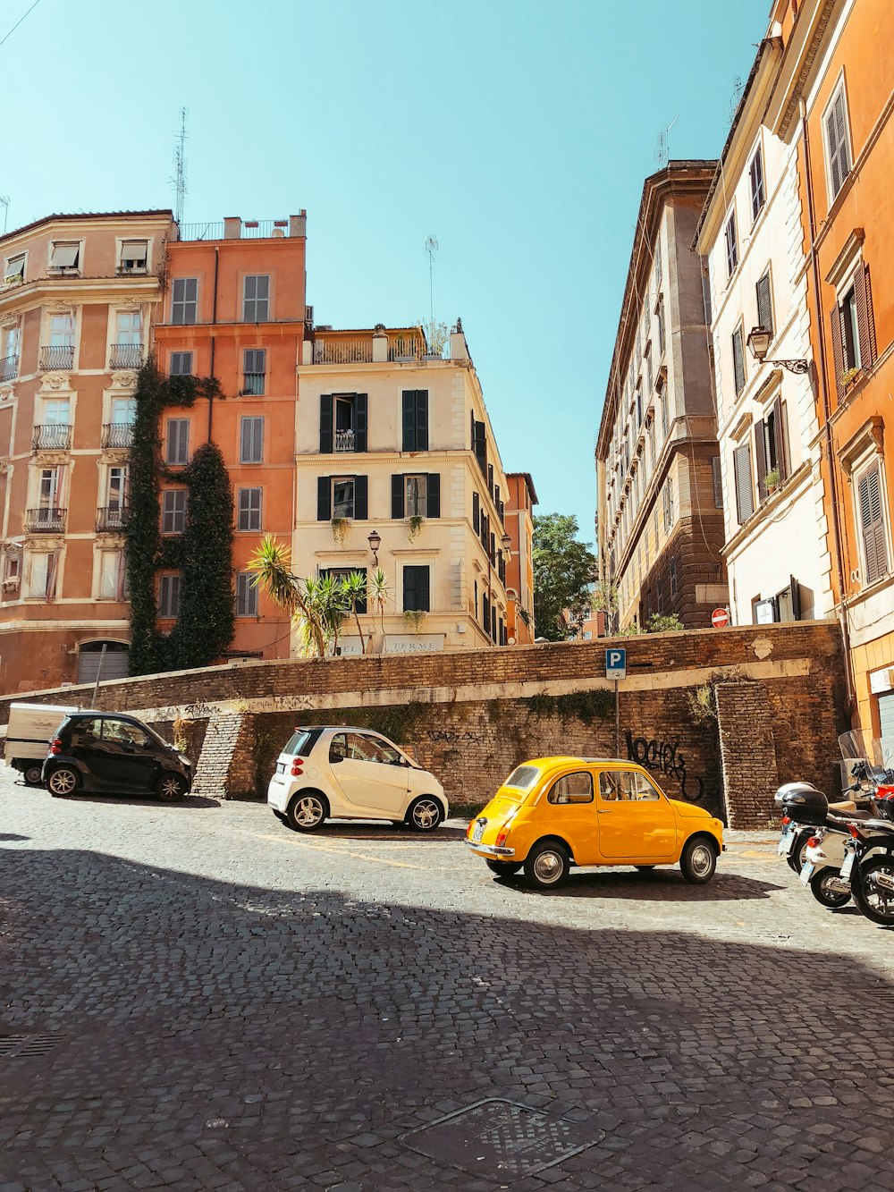 yellow mini cooper in front of building