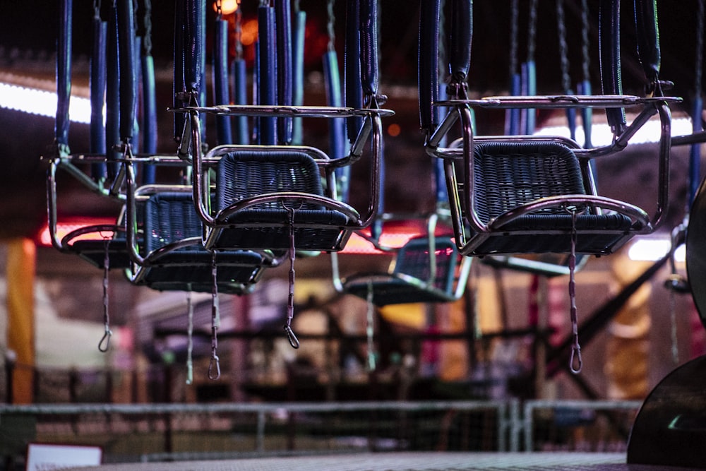 selective focus photography of gray hanging chairs