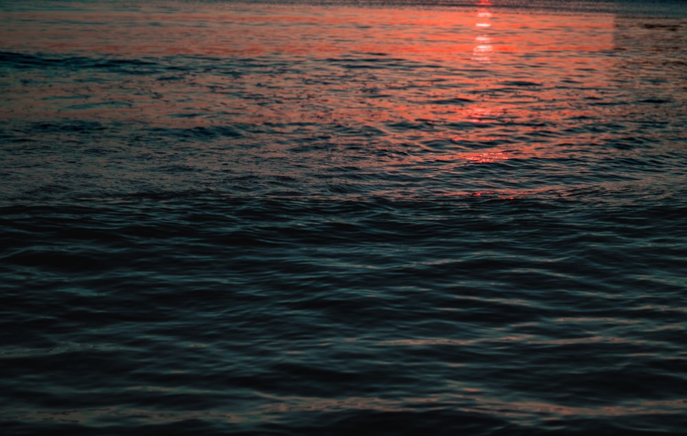 calm body of water at dusk