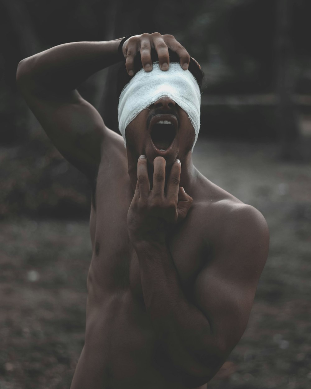 Photo d’un homme aux seins nus avec un bandage sur les yeux