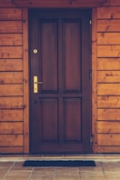 black wooden 4-panel door closed