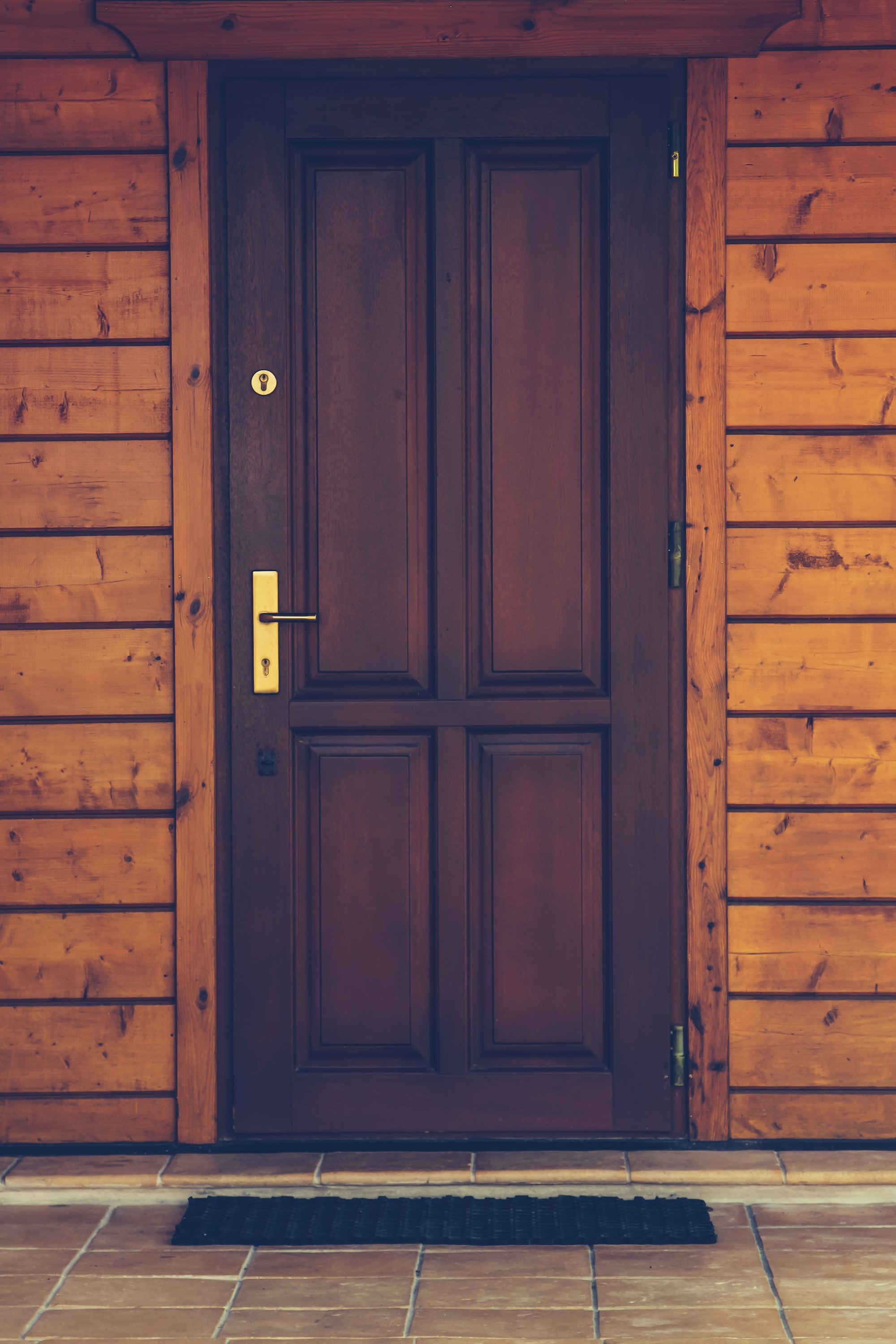 Photo of a brown door in a wooden house