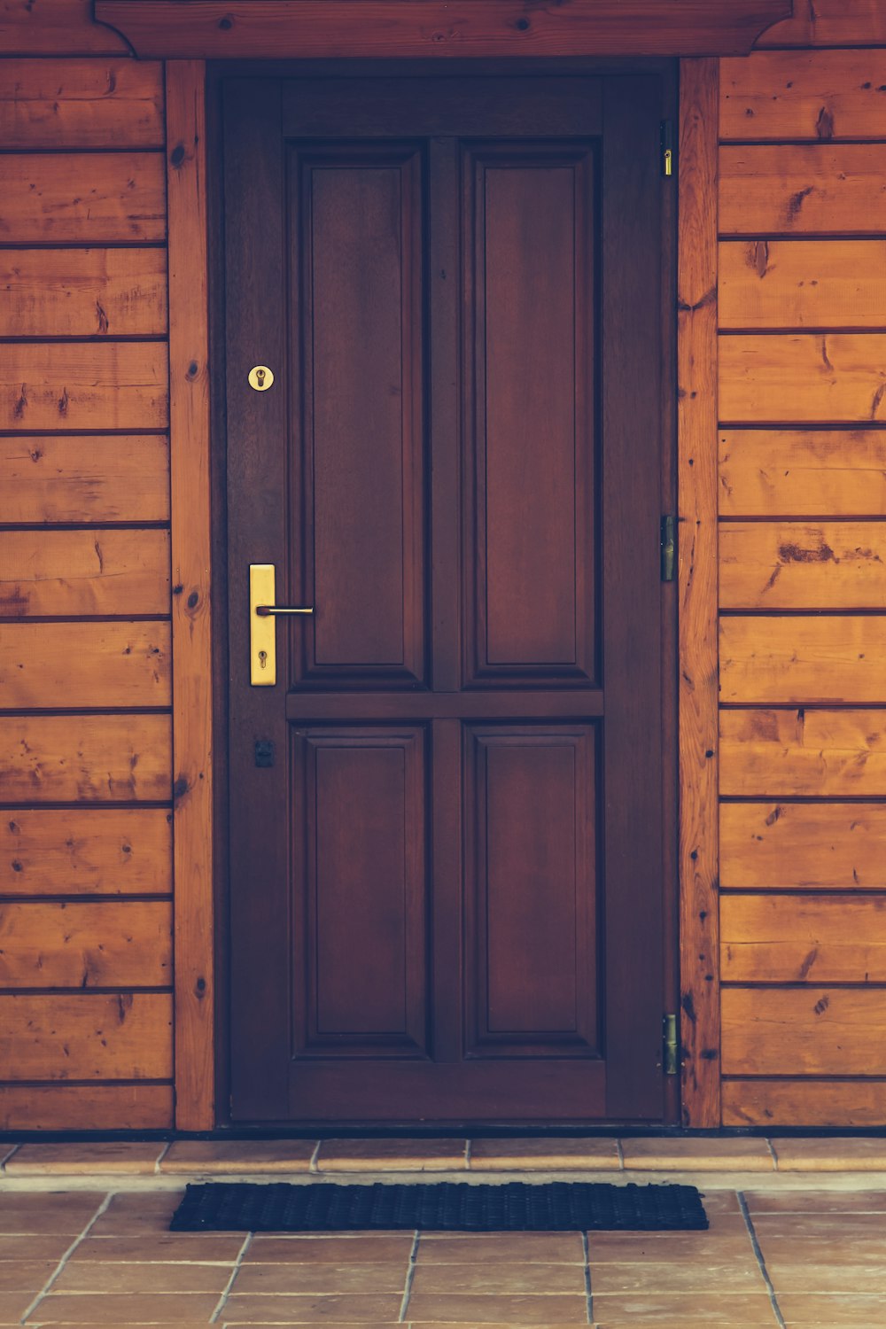 black wooden 4-panel door closed