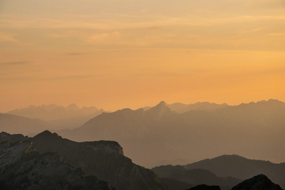 sunrise over mountains during foggy day