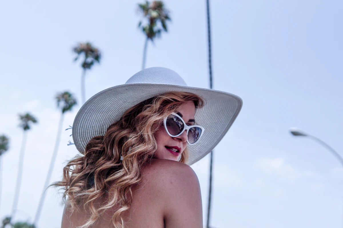 Woman wearing a wide-brim white sun hat