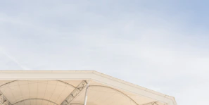 Wide shot of a public space covered by a sleek tensile roof designed by Geotens SAC.