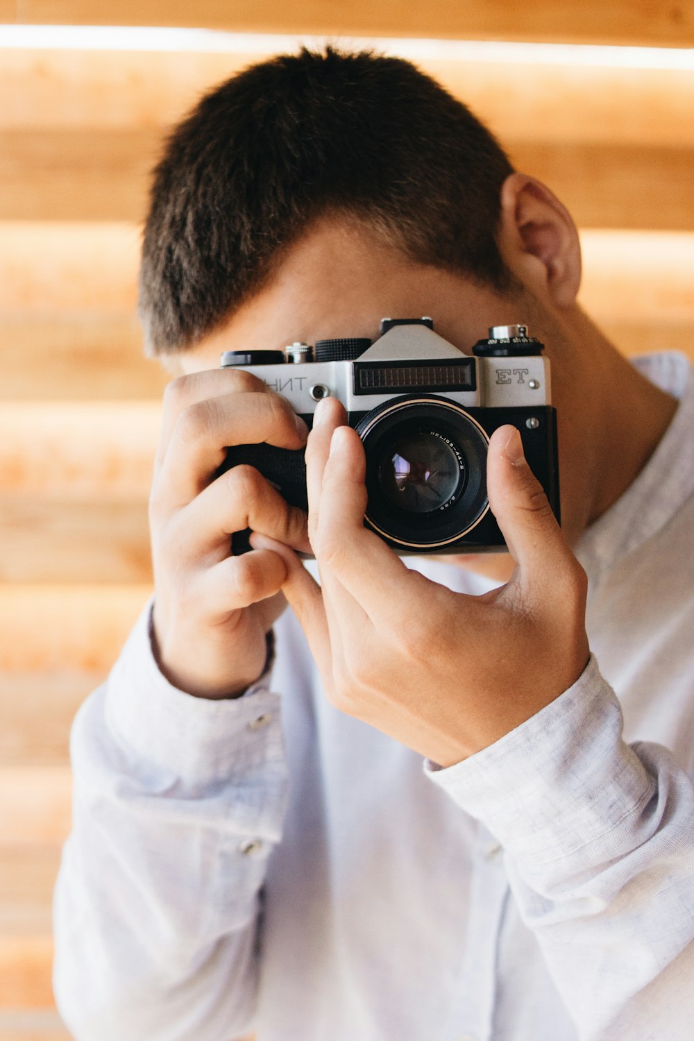 person holding gray and black camera