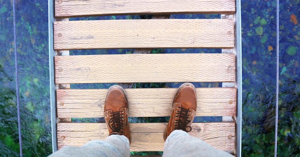 person standing on brown pallet