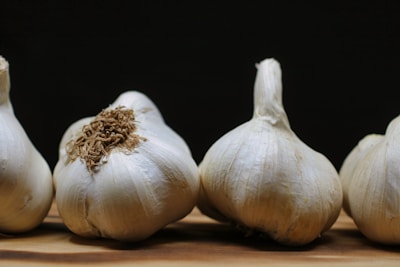 Fresh garlic bulbs arranged on a wooden table