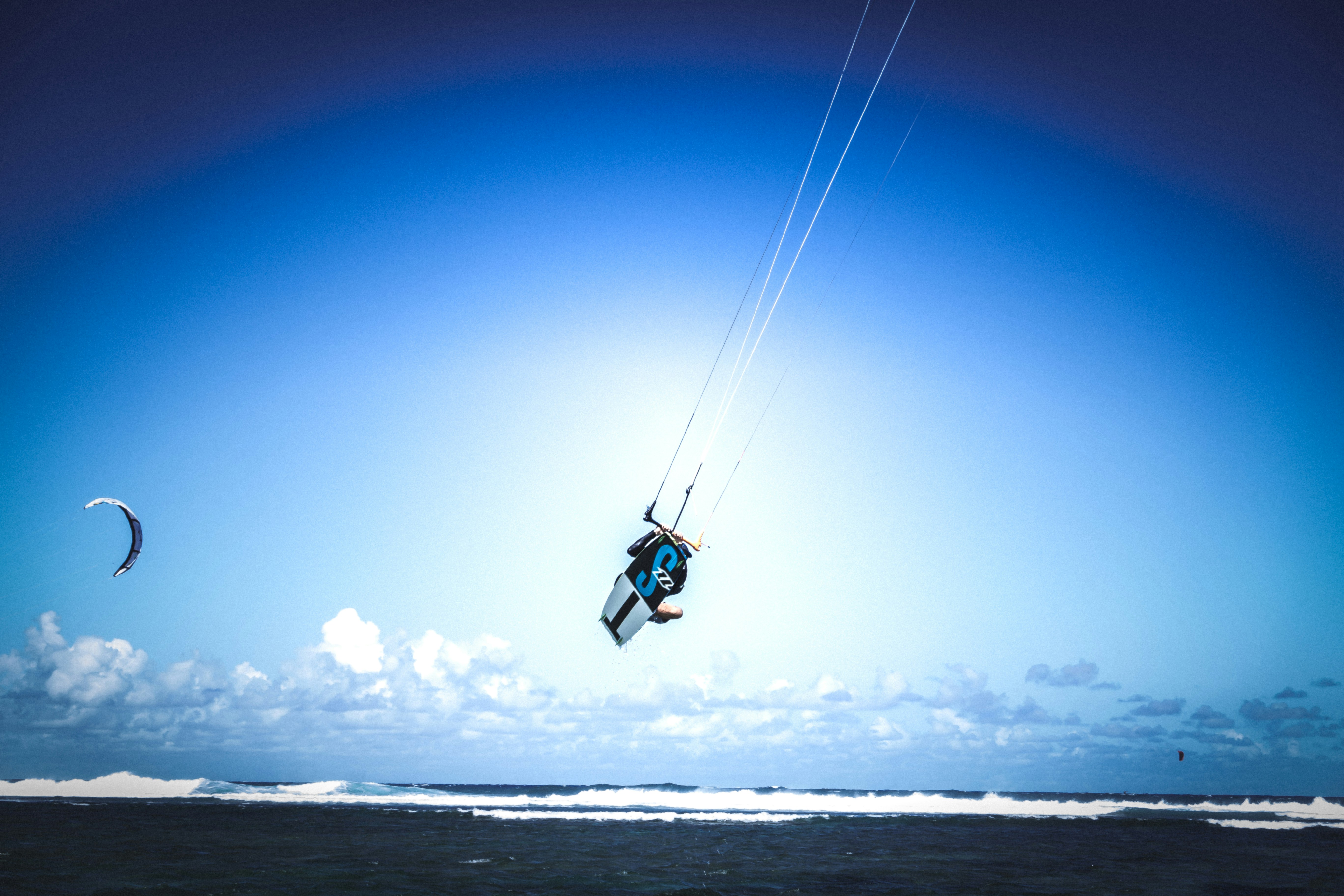 Kitesurfer jumping over El Gouna lagoon with clear sky