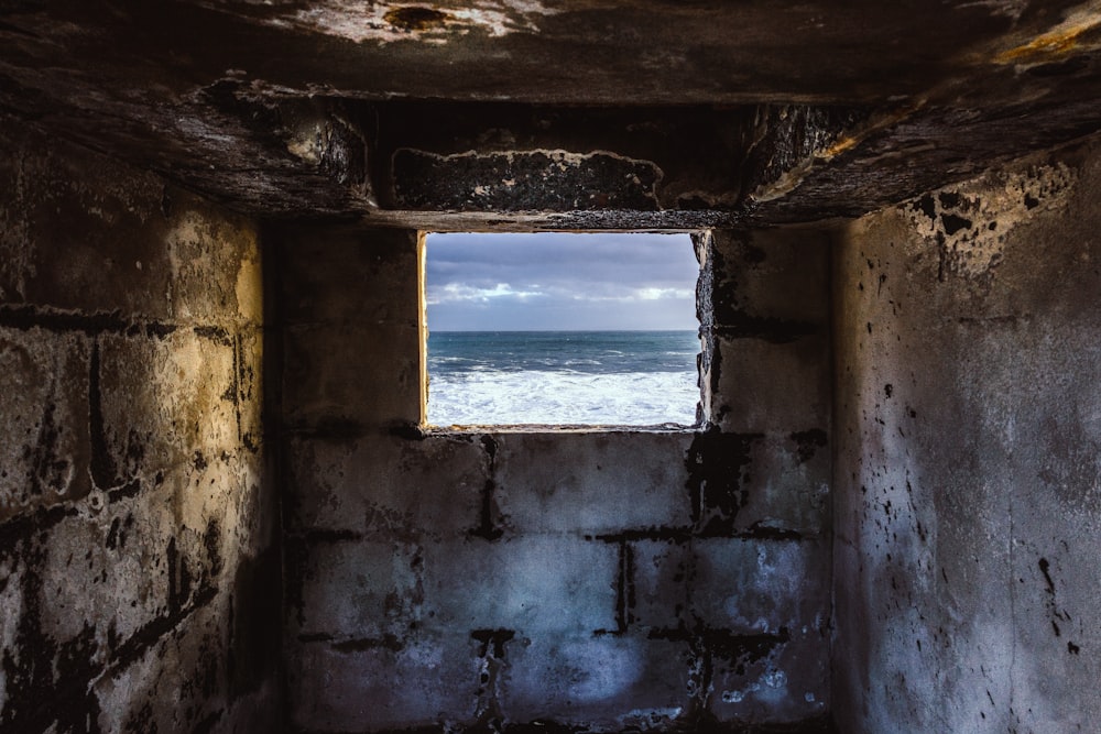 grey concrete window overlooking body of water