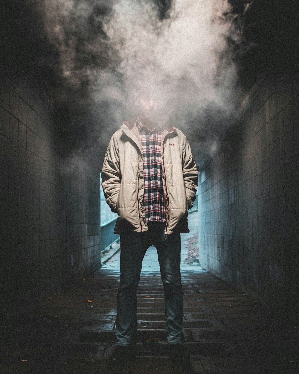 man standing in tunnel with white smoke