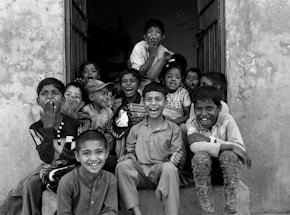 A welcoming school entrance with children and parents chatting happily.