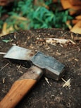 gray and brown axe on brown log