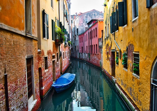 blue boat on Venice Canal at daytime in Campo San Polo Italy