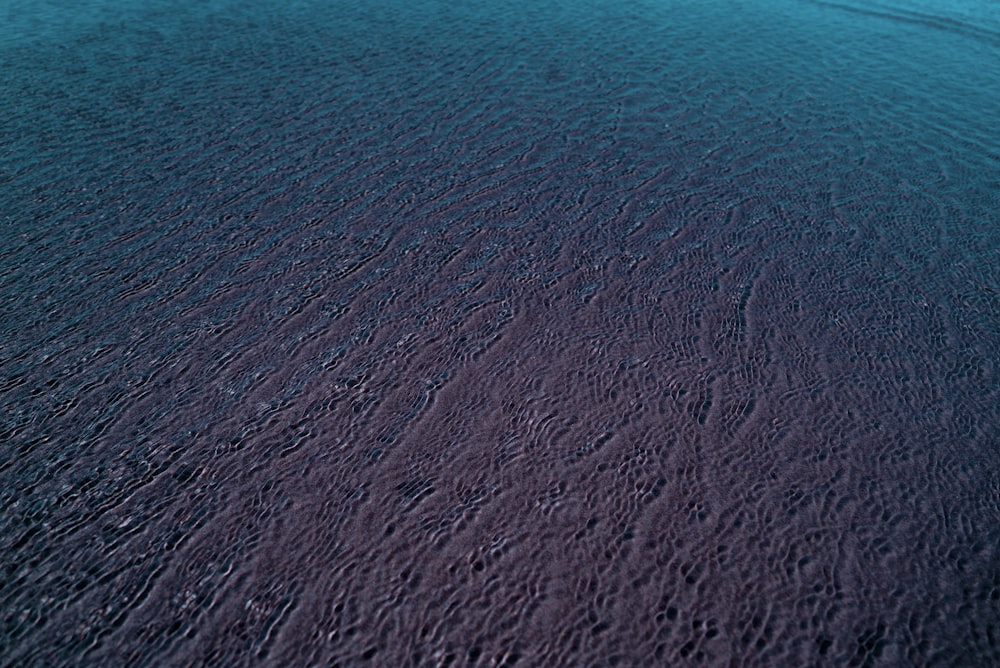 a large body of water sitting next to a sandy beach