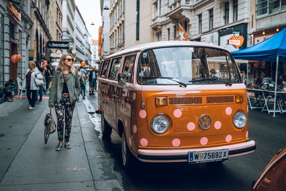 woman walking by parked vehicle