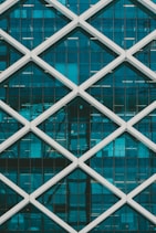 teal and white high-rise building at daytime