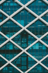 teal and white high-rise building at daytime