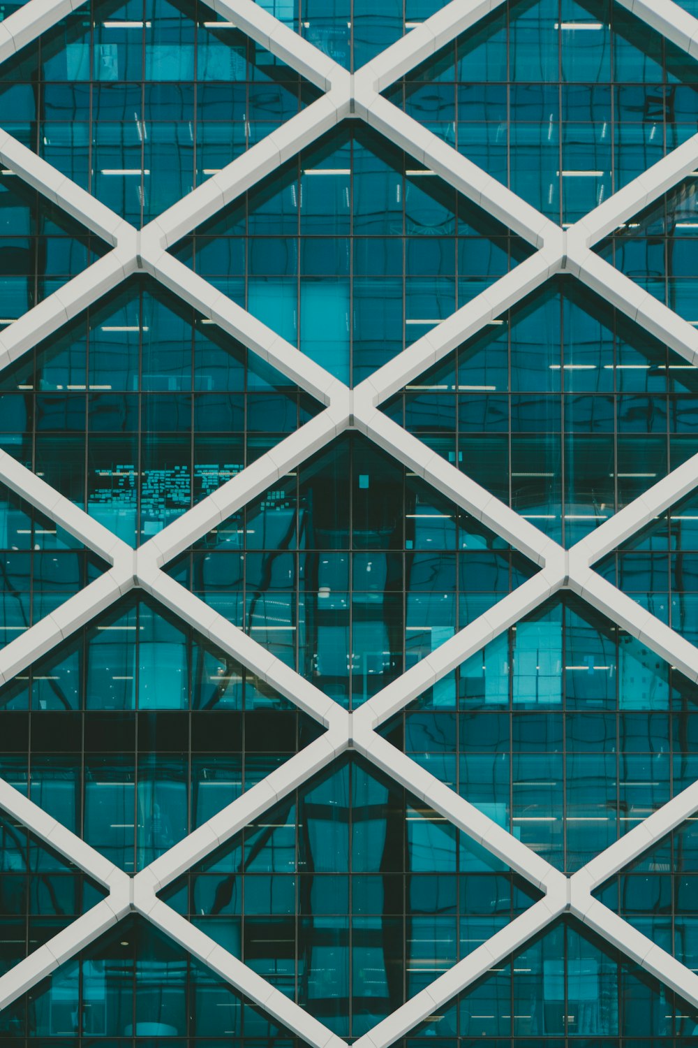 teal and white high-rise building at daytime