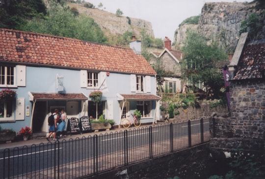 person in front of white house in Cafe Gorge United Kingdom