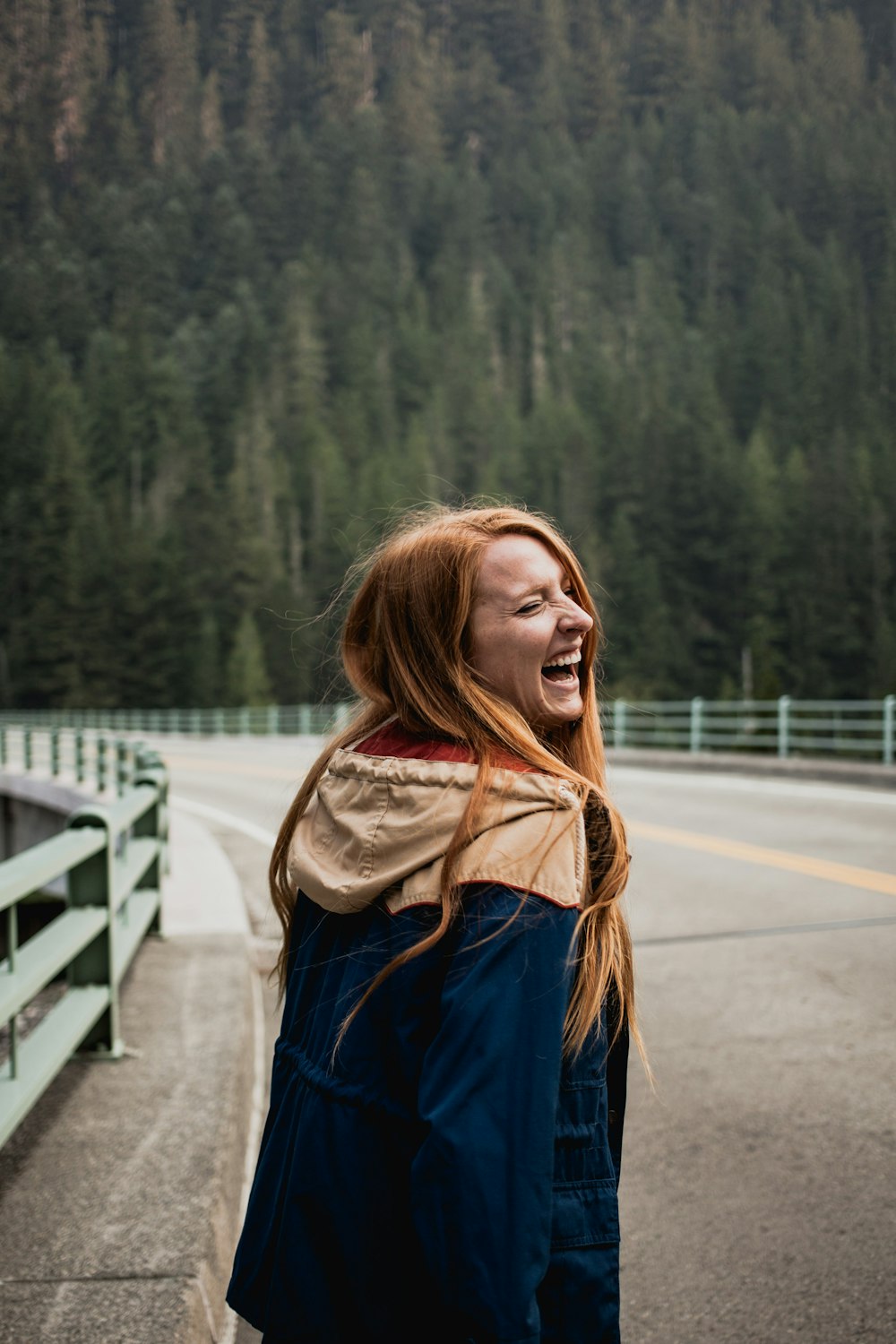 smiling woman leaning on right on road