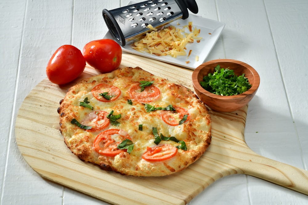 cooked pizza on brown wooden pizza board