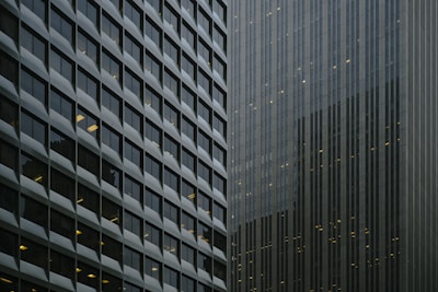 Urban commercial buildings reflecting in glass windows.