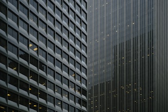 Urban commercial buildings reflecting in glass windows.