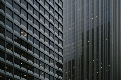 Commercial office complex with glass windows reflecting cityscape.