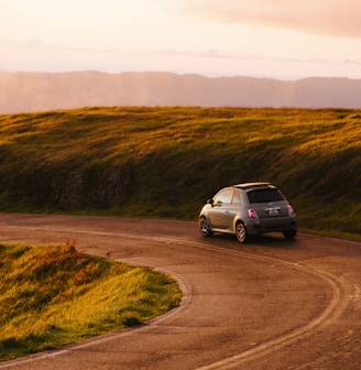 gray 3-door hatchback on road