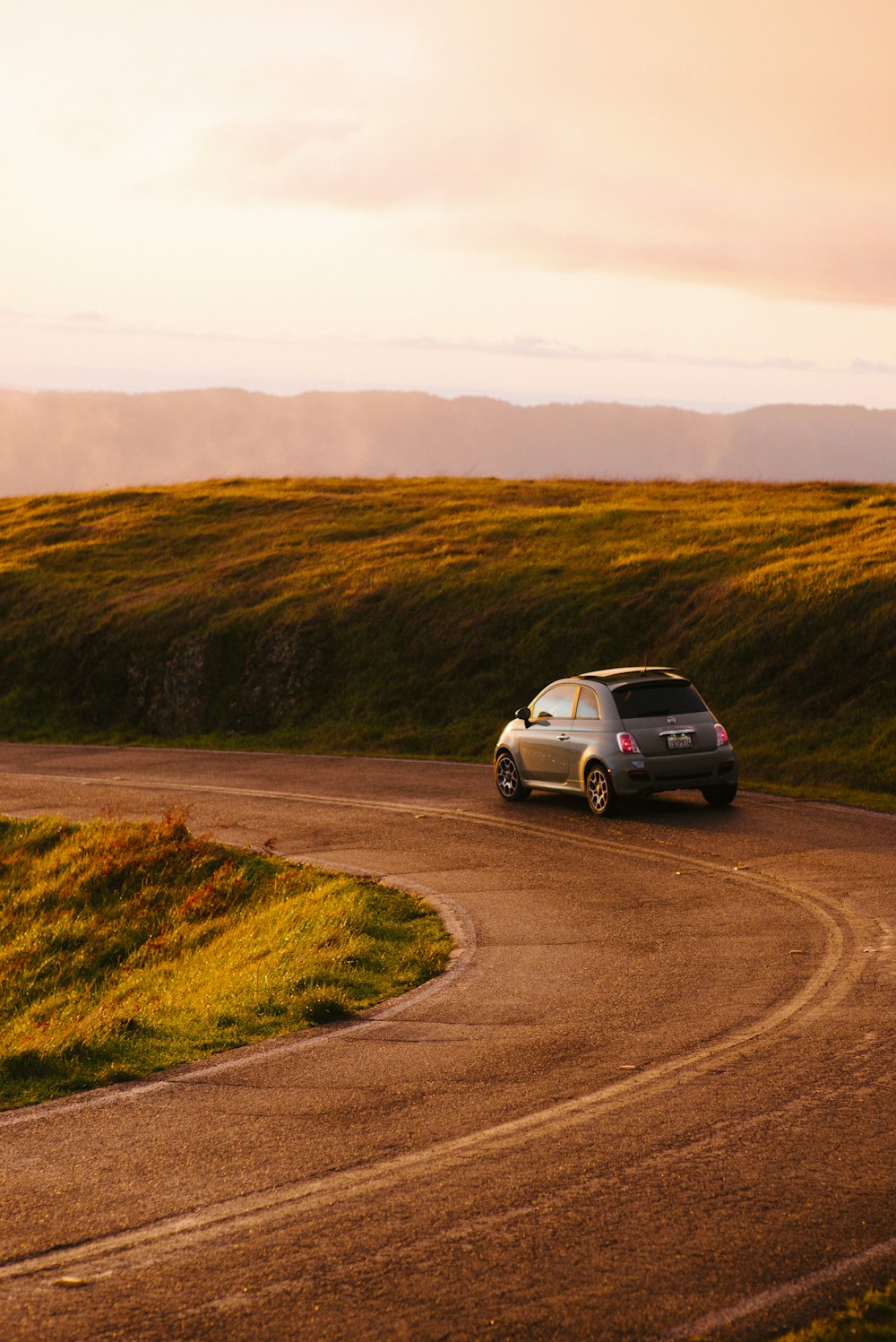 gray 3-door hatchback on road